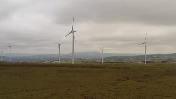 Drone footage over wind turbines on a wind farm