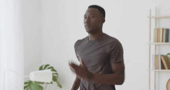 Head and Shoulders Shot of Young African American Guy Practicing Cardio Workout at Home