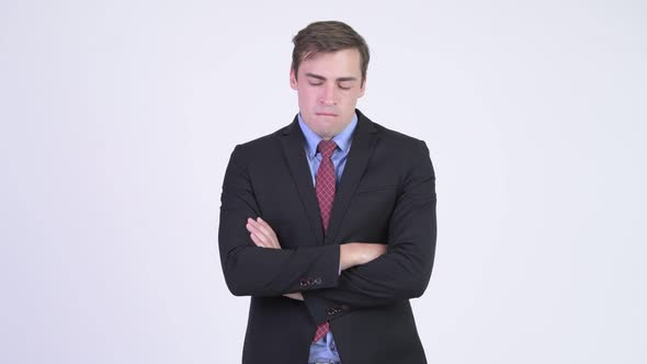 Young Angry Businessman with Arms Crossed