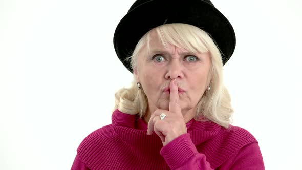 Elderly Woman Showing Silence Gesture