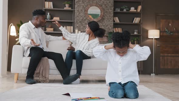 Sad Little African Daughter Child Kid Girl Closing Ears Upset at Parents Fighting Arguing Quarrel