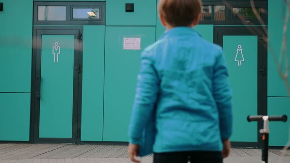 A Little Boy Looking at the Signature of Male and Female Toilet