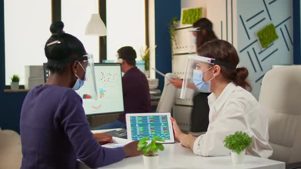 Multi Ethinc Women with Protection Masks Analysing Annual Reports