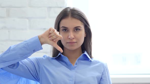 Hispanic Young Woman Gesturing Thumbs Down