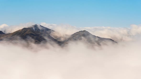 White Clouds Moving Fast in Alpine Mountains Valley in Sunny Day