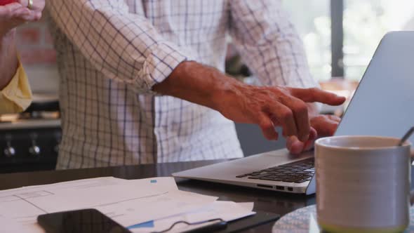 Senior Caucasian couple working together on a laptop at home