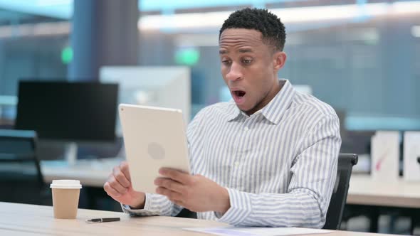 African Businessman Reacting to Loss on Tablet