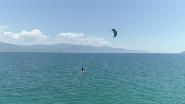 Aerial view of person kitesurfing in the Gulf of Patras, Greece.