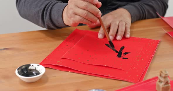 Man Write Chinesse Calligraphy for Lunar New Year