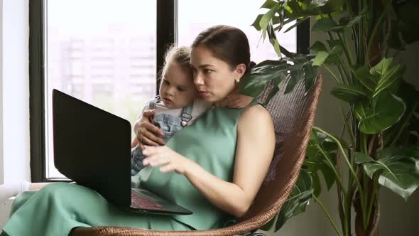 Woman Teaching Child to Use Laptop Device Iroi