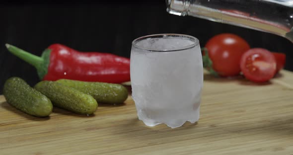 Man Puts Icy Glass Then Fills It with Vodka and Picks Up a Glass