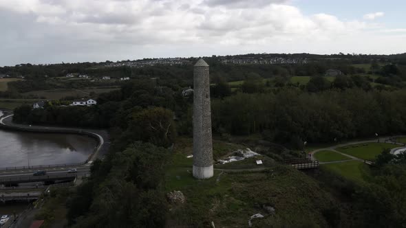 Drone shot of a round tower with countryside in the background.