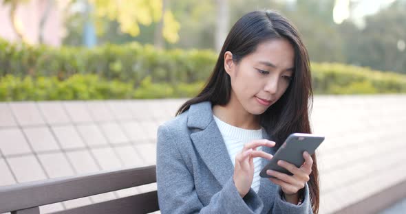 Business woman using smart phone at outdoor