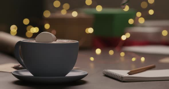 Slow Motion Man Put Marshmallow in Hot Chocolate in Blue Cup in the Evening with Shopping List for