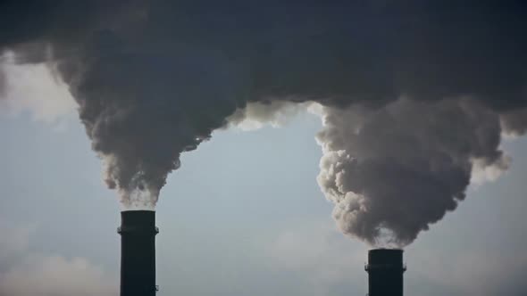 Industrial Zone with a Large Red and White Pipe Thick White Smoke Is Poured From the Factory Pipe in