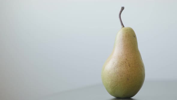 Organic fruit from genus Pyrus 4K 2160p UltraHD tilting footage - Close-up of yellow pear on the tab