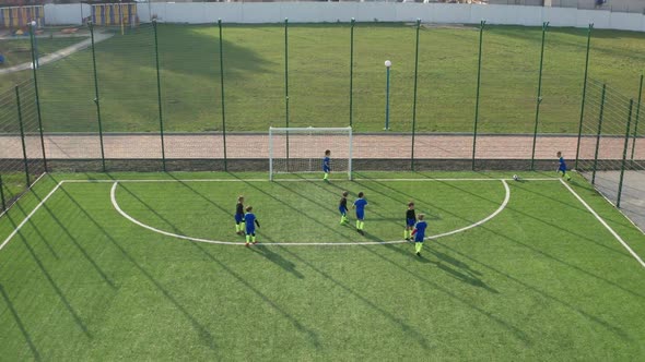 Kids Soccer Team Playing on Green Football Field