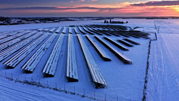 Photovoltaic farm at sunset in winter, aerial view