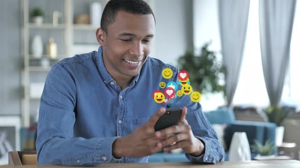 Happy African Man Using Smartphone, Emojis, Smileys and Likes