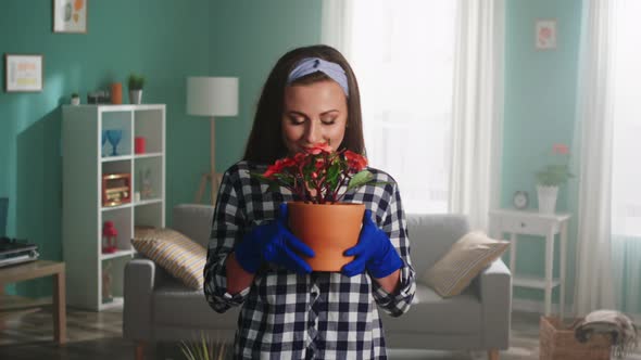 Woman Is Smelling A Houseplant