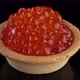 Snack with red caviar. Tartlet with red caviar close-up, rotation. 4K UHD video - VideoHive Item for Sale