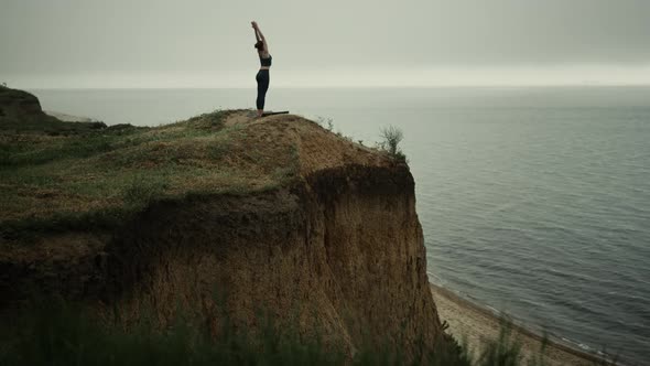 Athletic Woman Stand Straightening Up Beach Hill Stretch Hands to Gray Sky