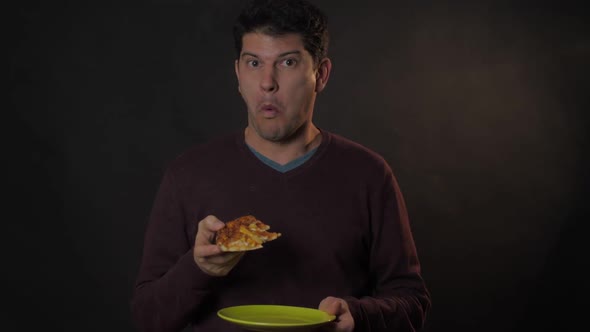 Excited Guy Eats Pizza with Happy Face Holding Plate