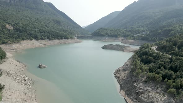 Drone Shot Over the Ayous Lake with Receding Level of Water During Autumn Season with Lush Green