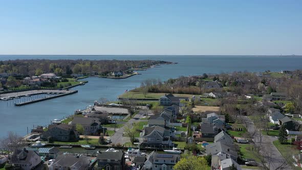 A high angle view over Bay Shore, NY, on a sunny day with clear skies. The camera dolly in over the