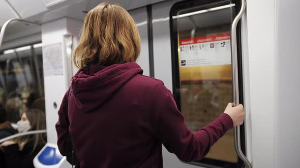 Woman Standing in Front of the Door Get Out Underground Carriage