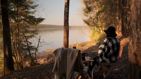 A young girl on a picnic with a tent fries marshmallows