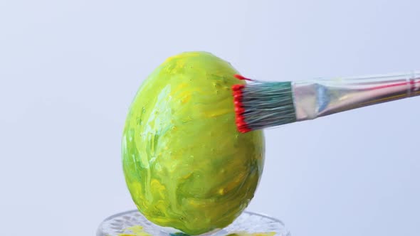 Closeup of a Person Painting Easter Eggs with a Special Brush