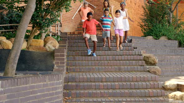 Group of kids getting down from staircase