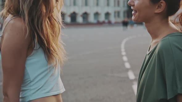 Two Fashion Hipster Women Close Friends Hug at Hot Summer Day and Skateboarding Lifestyle. Outdoor