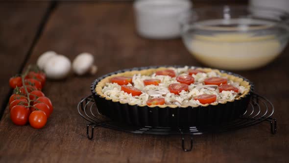 Step by step woman making Quiche Lorraine with chicken, mushrooms and cheese.French cuisine