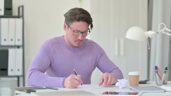 Middle Aged Man Failing to Write on Paper