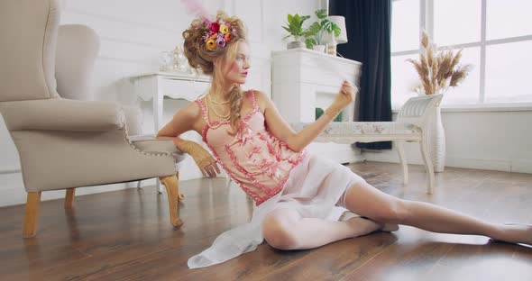 Royal Woman From 18Th Century Is Sitting on the Floor and Leaning on the Chair