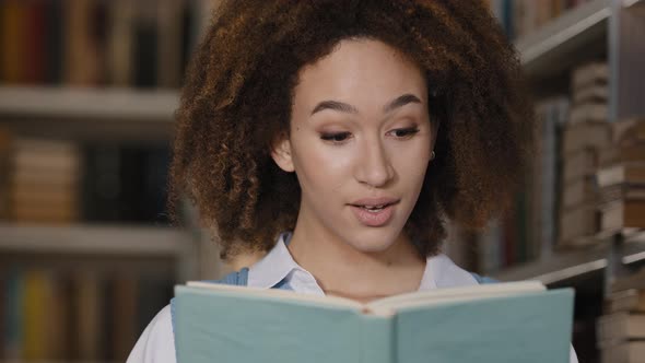 Closeup African American Girl Student Hiding Behind Textbook Reading Book Emotional Young Woman