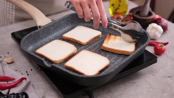 Toasting Slices of Toast Bread in a Grill Frying Pan