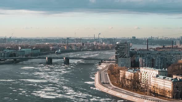 Timelapse of the City Embankment with Floating Ice Floes and Cars From a Height