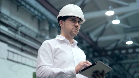 Engineer Is Using Tablet Pc In Factory