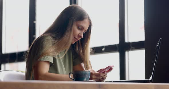 Woman Working with Laptop in Small Restaurant