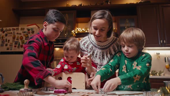 Family with Three Kids Cooking Ginger Cookies