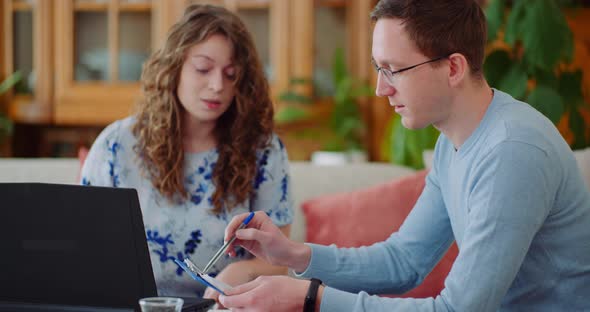 Couple Calculating Bills at Home