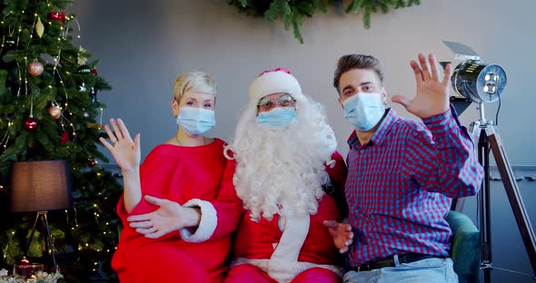 Cheerful Young Couple Wearing Face Masks Santa Claus Hat Sitting Home Waving Their Hands