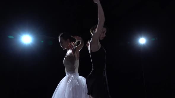 Perfect Ballerinas in White and Black Tutu Spinning in Dance. Close Up, Slow Motion