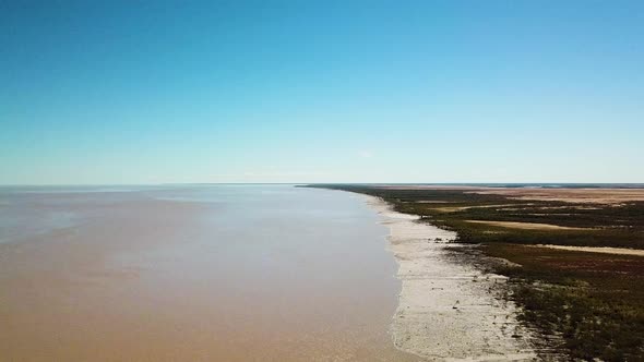 Rising wide angle drone footage showing tidal mudflats in King Sound, Australia, location of second