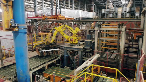 Factory Equipment with a Robotic Arm Moving Around
