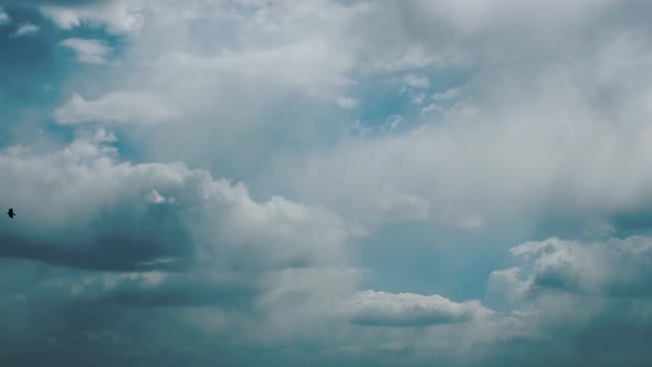 Sun Rays Shining Through Cloudy Rainy Sky With Fluffy Rain Clouds