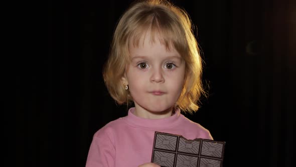 Attractive Child Eating a Huge Block of Chocolate